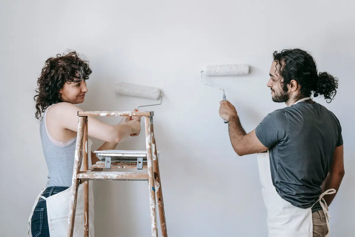 People painting a wall together — painting help in Rochester